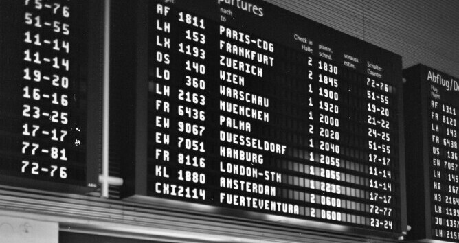 airport departures voard showing the time in 24-hour clock